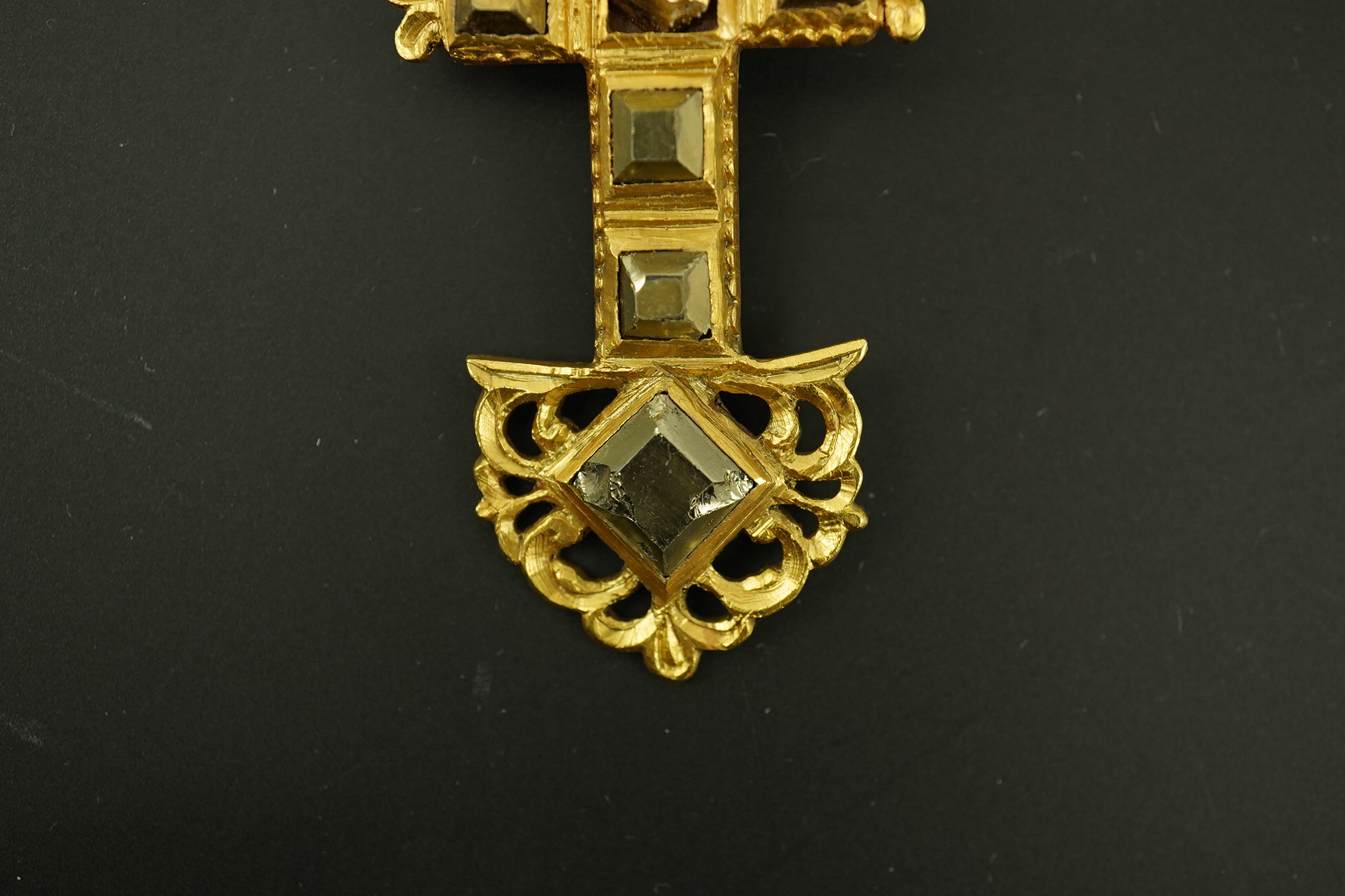 An antique continental engraved gold and seven stone pyrites? set cross pendant, with a gold, emerald and seed pearl set suspension brooch attachment